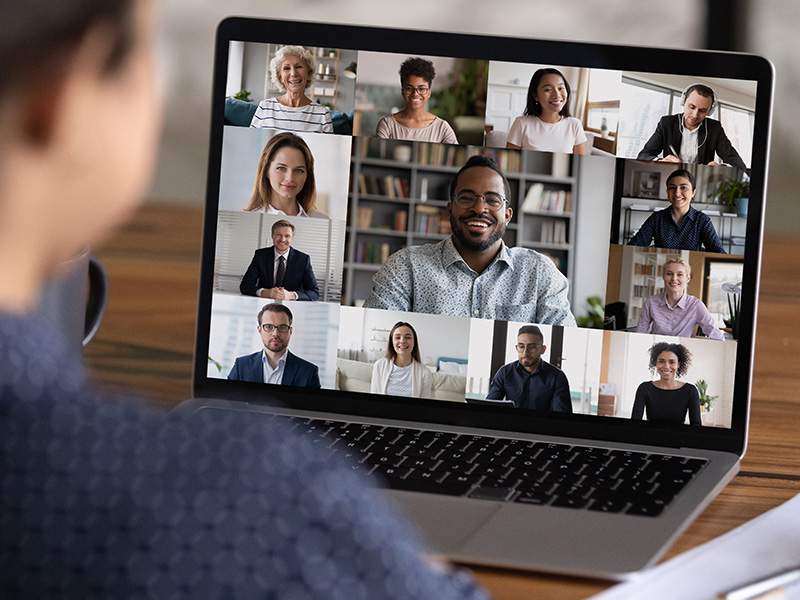 business professional viewing a virtual event on their laptop